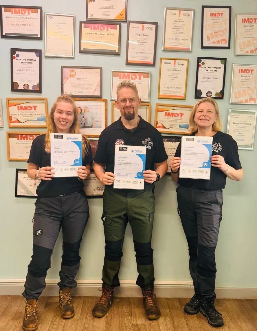 The three dog trainers at Barkleys Abbie, Kris and gee holding their certifications