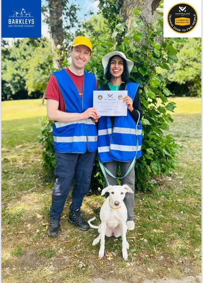 two owners and their dog graduating mantrailing
